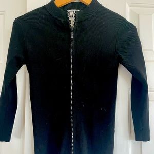 Black knit sweaters with the zipper being rhinestones.